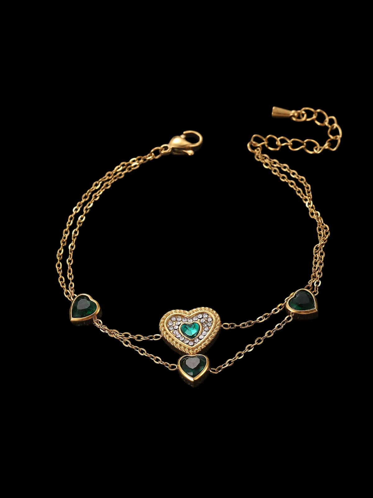 A double-chain bracelet with green heart-shaped stones and an ornate central heart.